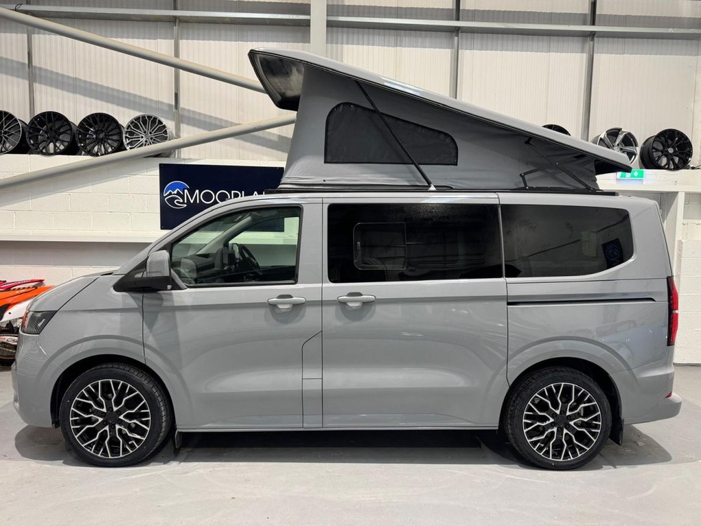 Grey VW Transporter campervan, side profile with pop-top roof raised