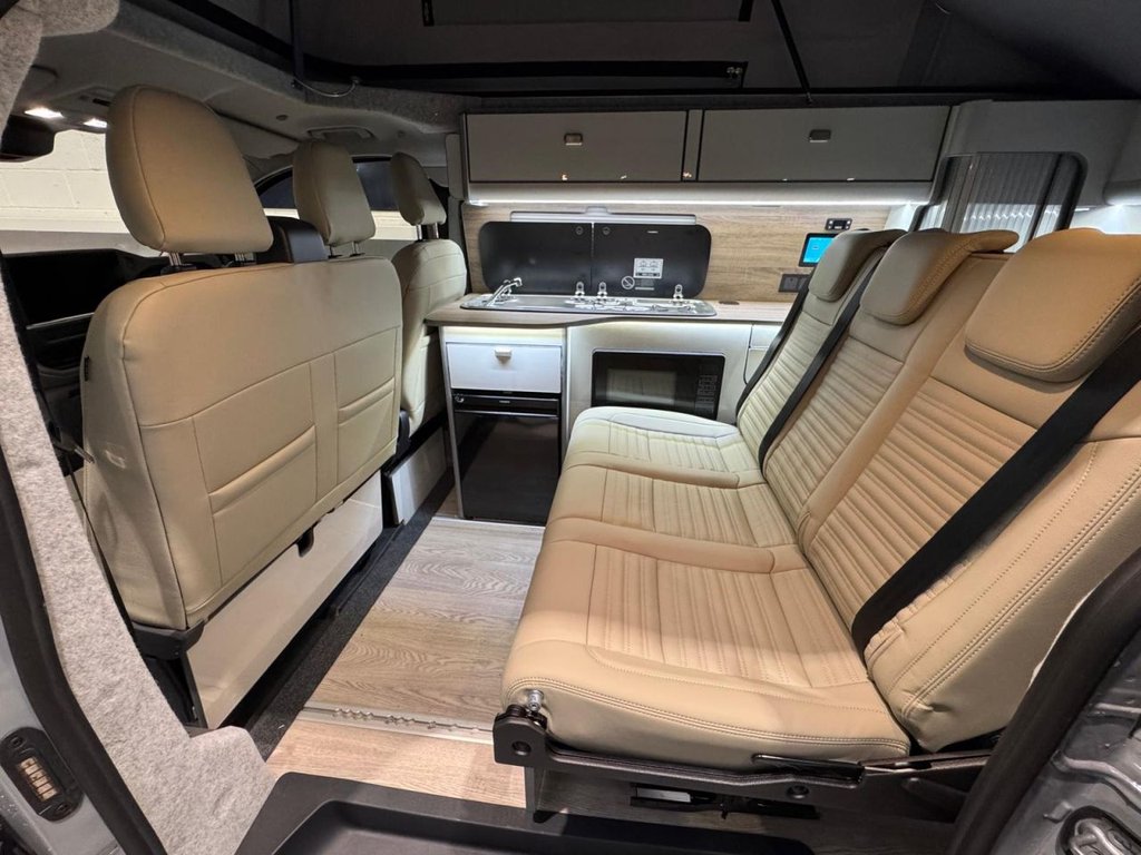 Rear bench seat and kitchen unit with microwave and fridge